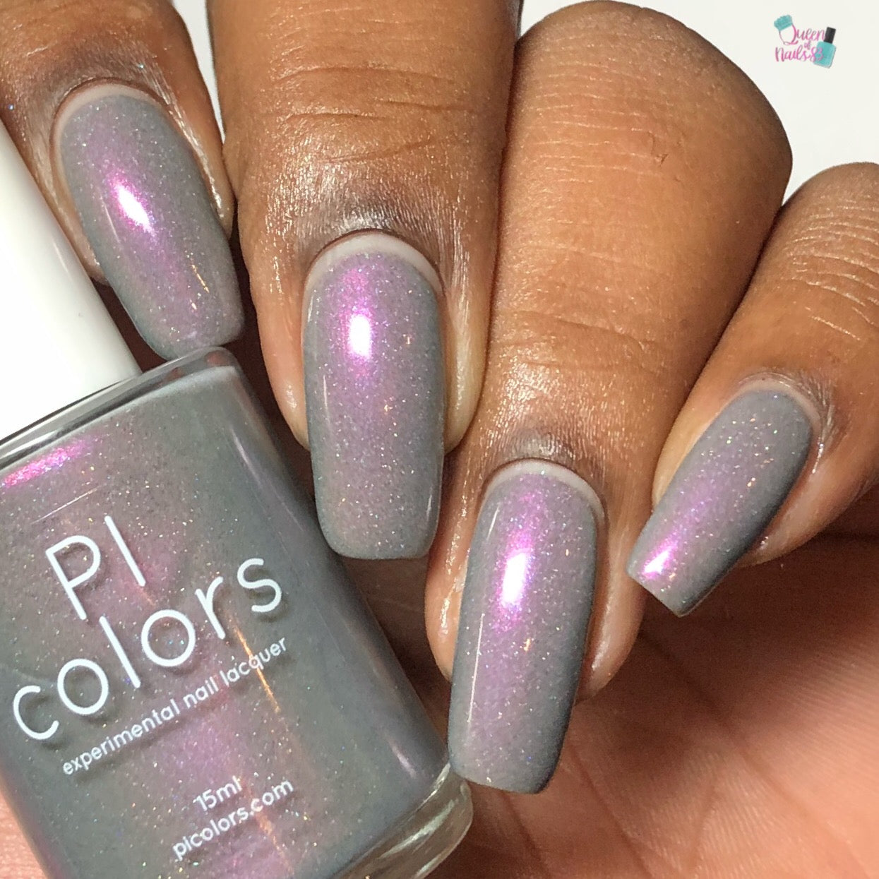A hand showcases nails adorned with a shimmery pink-gray polish enriched with a purple shimmer. The thumb holds a bottle labeled "PI Colors," featuring the same 10-free, beautiful polish called Cirrus.118.