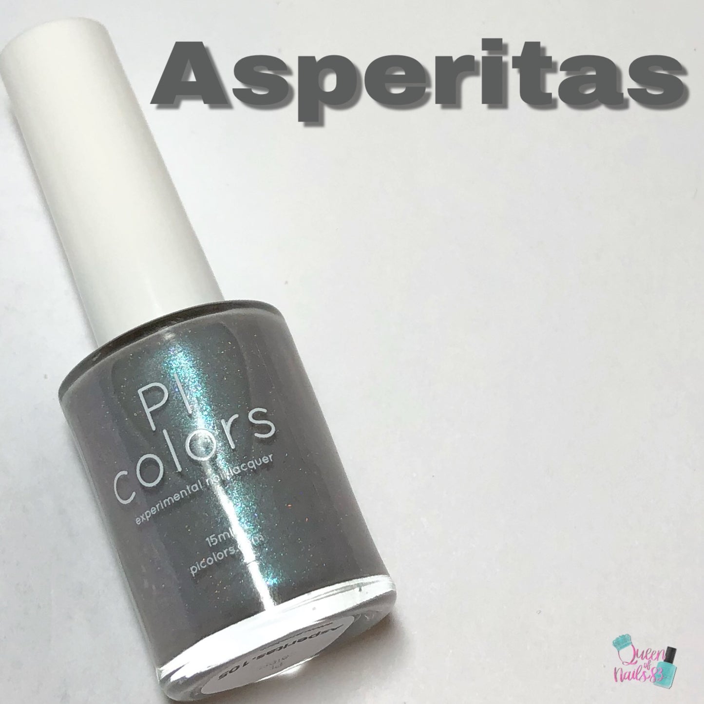 An angled display showcases a bottle of PI Colors nail polish in a glossy, metallic blue-gray shade, accented by a subtle holographic shimmer. The name "Asperitas" is prominently featured in bold, gray lettering at the top. The bottle's cap is white, and the background is uncluttered.