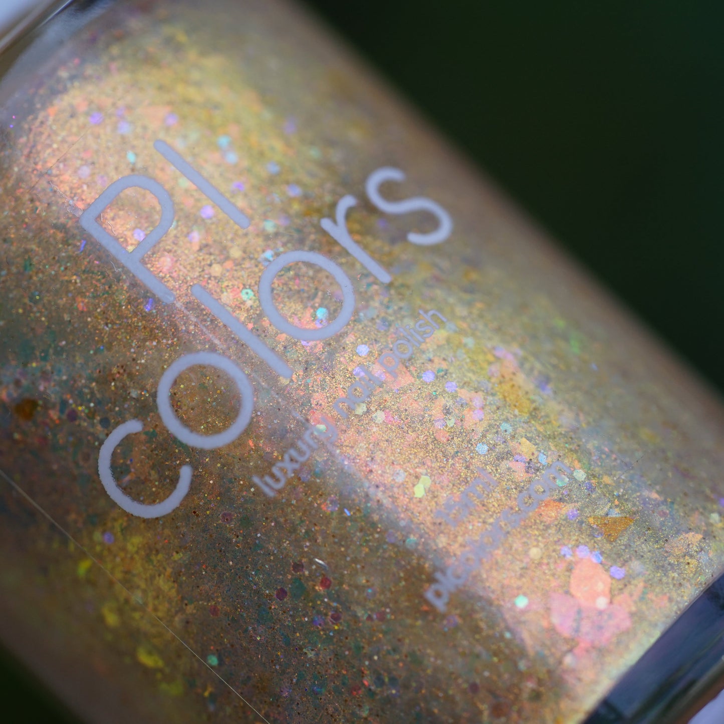 Close-up of a glittery nail polish bottle with 'PI Colors' branding.