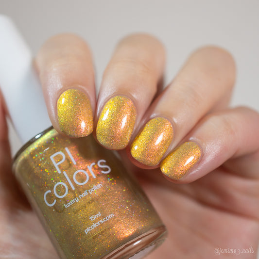 The image features a close-up of a hand with short nails adorned with a shimmery, golden-yellow nail polish. In the hand, an elegantly held bottle displays the label "PI Colors." This luxurious nail polish, named Golden Fuyuki.000, boasts a glossy and iridescent finish complemented by metallic gold holo glitter for an added touch of allure.