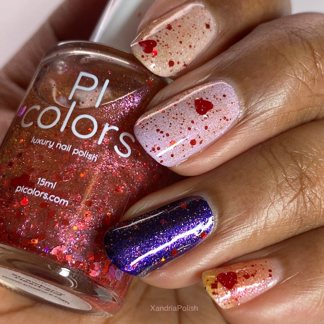 A hand with four uniquely painted nails holds a bottle of PI Colors' 10-free nail polish. Two nails are adorned with the translucent "Strawberry Heart.208 Red Nail Polish Topper," showcasing red glitter and holographic hearts. Another nail is coated in shiny purple with a silver stripe, while the last displays a gradient of pink and red glitter.