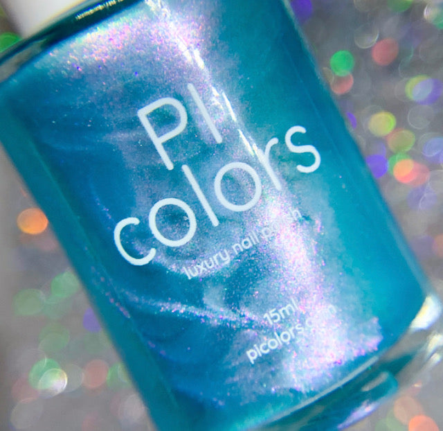 Close-up of a bottle of PI Colors Ocean Whitecap.309 Blue Nail Polish, featuring its shimmering teal hue and color-changing effects. The background is a soft bokeh, emphasizing the metallic and iridescent qualities of this exquisite blue-green nail polish.