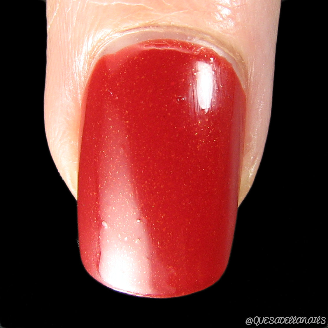In a striking close-up, the fingernail showcases the vibrant and sophisticated allure of PI Colors' Blood Moon.090 Red Nail Polish. This glossy luxury lacquer features a subtle shimmer and neatly manicured edges, while the black background further accentuates its bold hue. As a 10-free polish, it offers an unparalleled level of elegance.