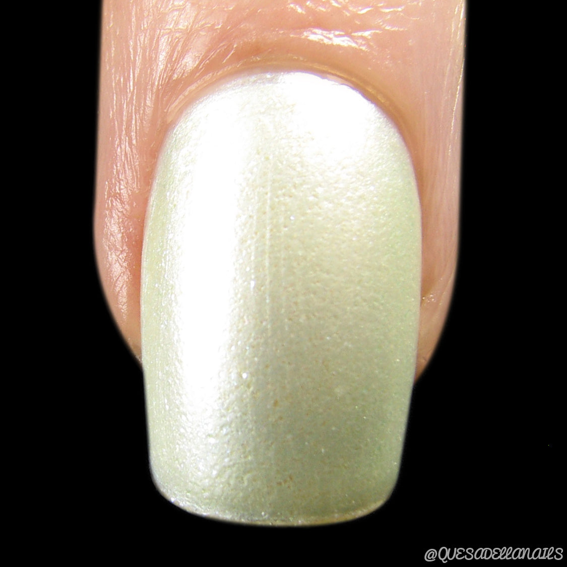 Close-up of a fingernail adorned with PI Colors' exquisite Ultralight.001 Yellow Nail Polish against a black background. The lacquer shimmers subtly, effortlessly catching the light.