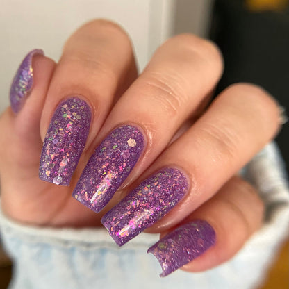 Purple nail polish with iridescent rainbow flakies and holo glitter by PI Colors