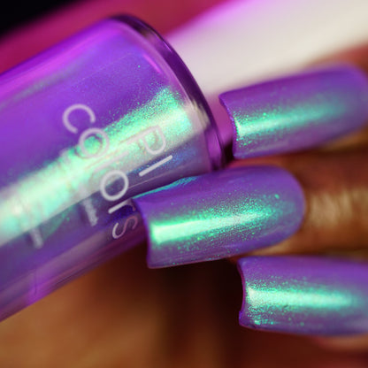 Close-up of a hand with iridescent purple nail polish 
