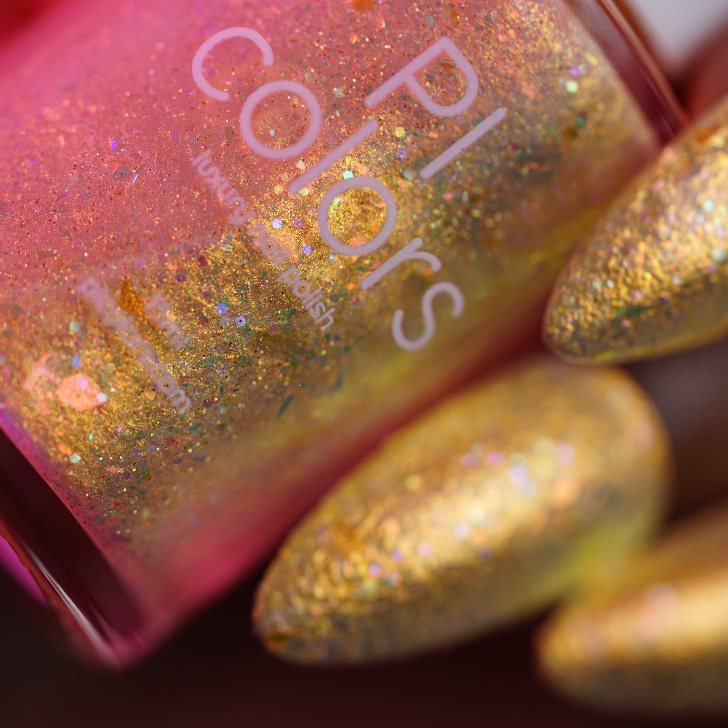 Gold glittery nail polish with PL Colors bottle and nails