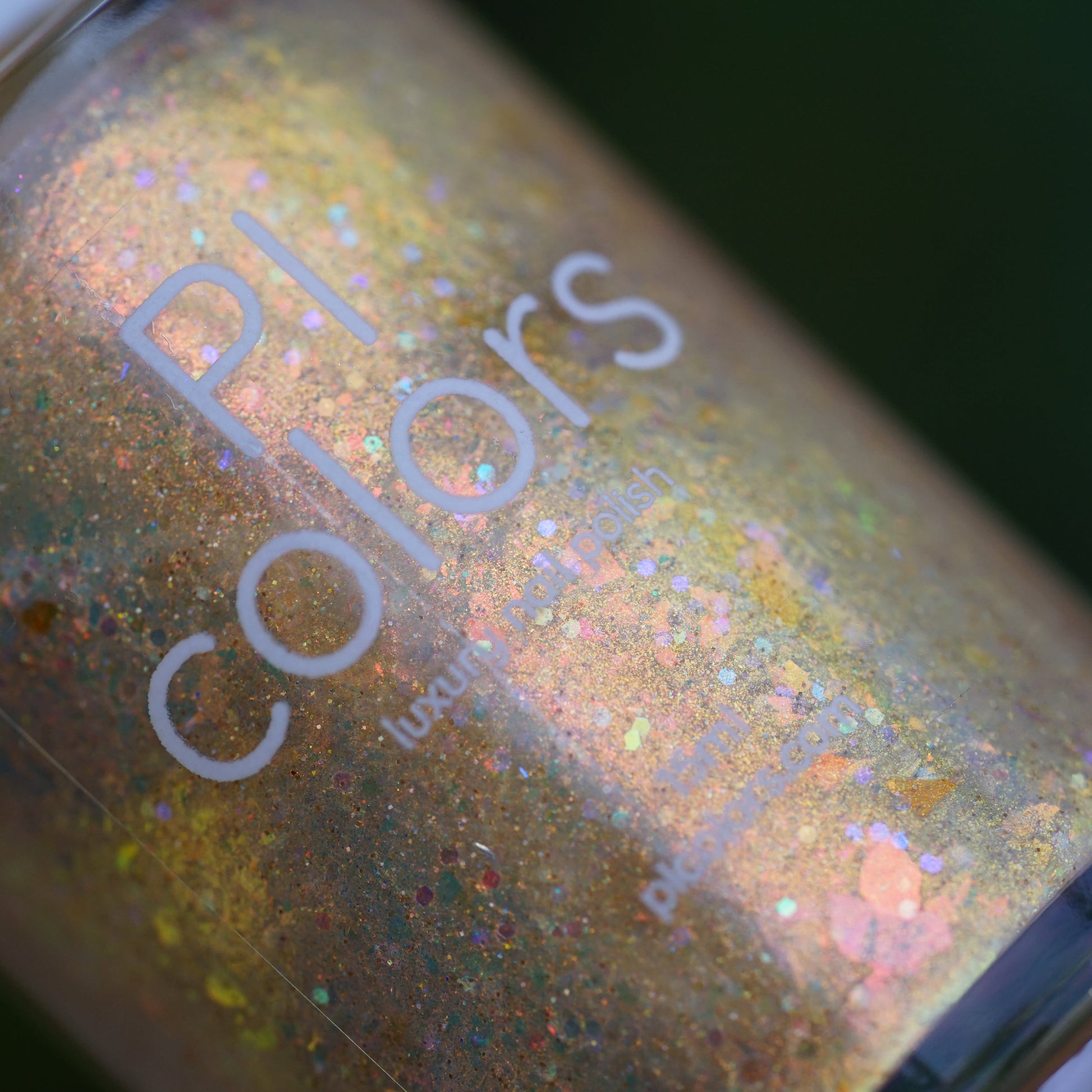 Close-up of a glittery nail polish bottle with 'PI Colors' branding.