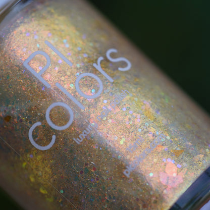 Close-up of a glittery nail polish bottle with 'PI Colors' branding.