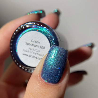 Hand holding a jar of glittery nail polish with a white label, against a neutral background.