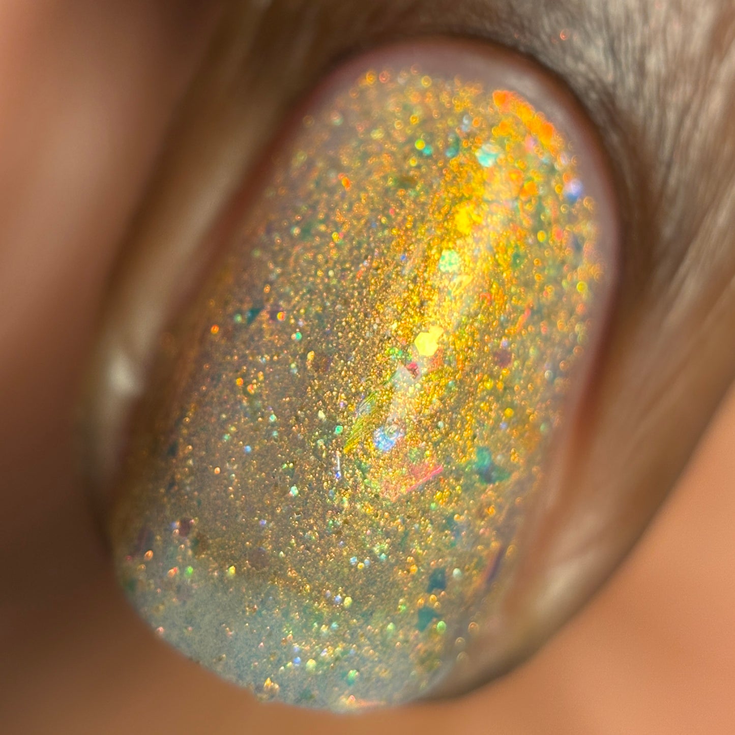 Close-up of a glittery nail polish on a person's nail