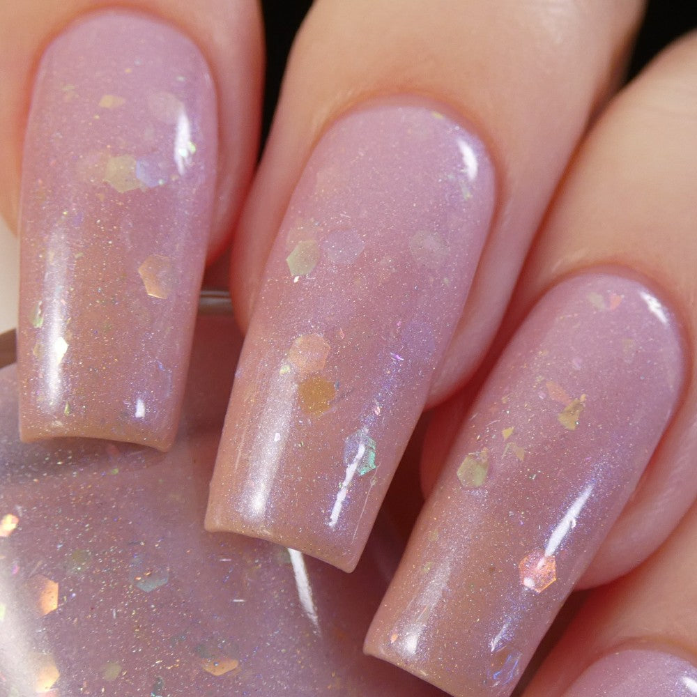 A close-up of nails adorned with Special Week.000 Pink Nail Polish by PI Colors, showcasing a pastel pink hue with holographic glitter. The long, smooth nails boast a shiny, opalescent finish that rivals the elegance found in Uma Musume Pretty Derby styles.