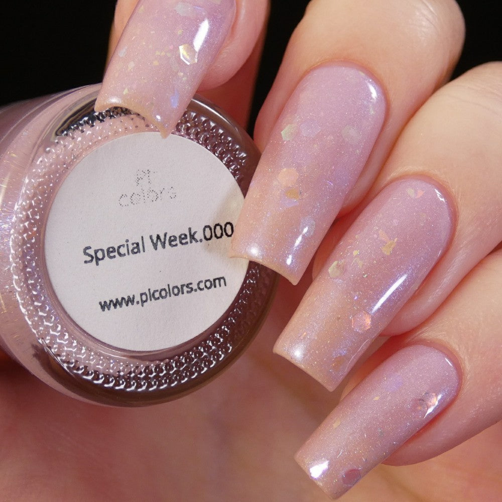 A close-up showcases a hand adorned with long, glossy pink nails accented by subtle sparkles, emitting the luxury of high-end nail lacquers. The thumb grasps a handmade bottle of PI Colors' "Special Week.000 Pink Nail Polish," complete with a website URL below the label.