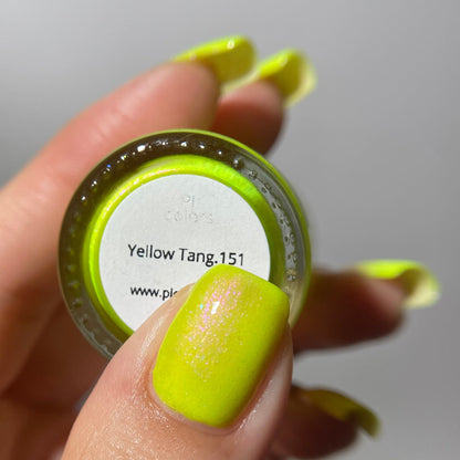 A close-up of a hand holding a small round jar of nail polish or pigment. The product color is a bright neon yellow-green, matching the swatch labeled 'Yellow Tang.