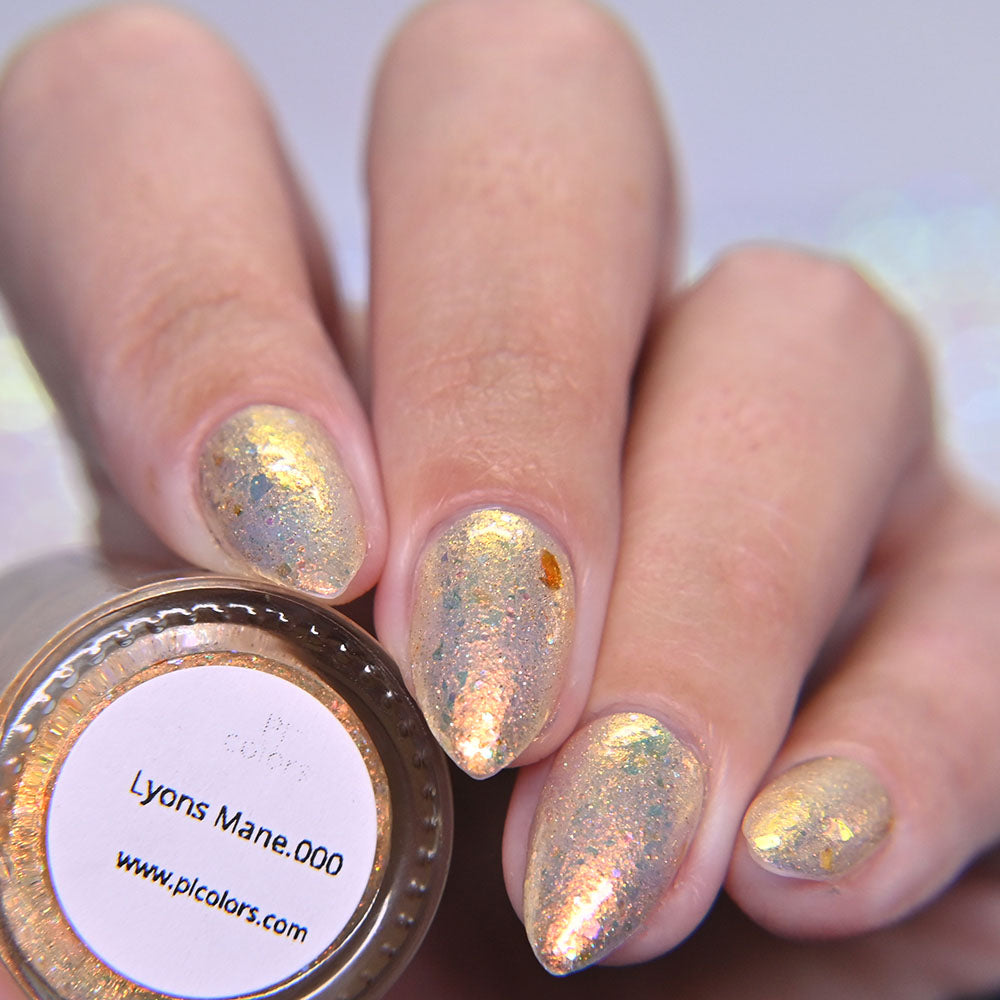 Nails with metallic gold nail polish and a container labeled 'Lyons Mane.000' by Picolors.