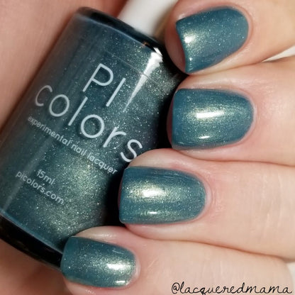 A close-up shows a hand with short nails adorned with PI Colors' "Sea Kelp.092" Green Nail Polish, featuring a handmade, shimmery teal finish. The sleek bottle, grasped between fingers, highlights its glossy appearance and the brand's website on the design.