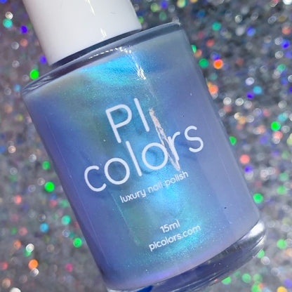 A bottle of PI Colors' Cloud Rainbow.303 Blue Nail Polish, featuring a luxurious electric silver-blue hue with an iridescent shimmer, set against a sparkling, multicolored background. This handmade polish is labeled with the brand information and "15ml" size, highlighting its mesmerizing color-changing effects.