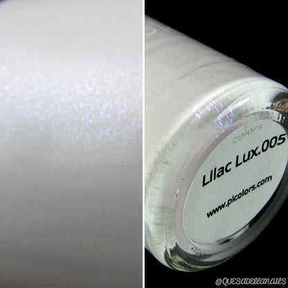 Close-up image of a nail polish bottle in a shimmering creme white shade with lilac undertones. The label reads "Lilac Lux.005" by PI Colors and includes a website URL. The light reflection highlights the polish's glittery texture, embodying its luxurious 10-free formula.