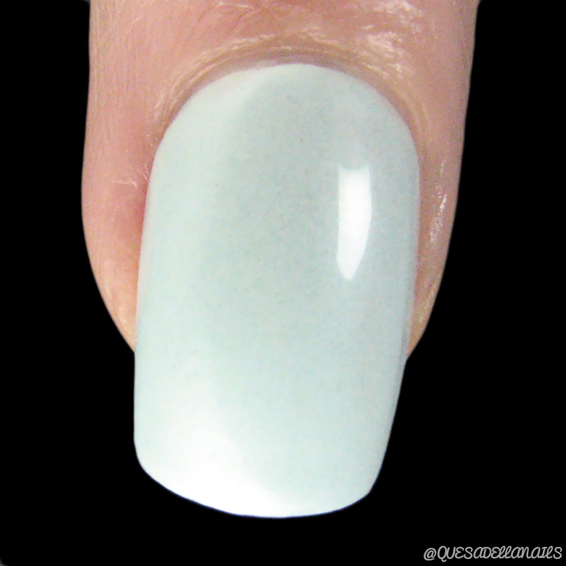 Close-up of a fingernail painted in Ocean Sky.045 by PI Colors, a glossy, light pastel blue shade handmade with 10-free nail polish.