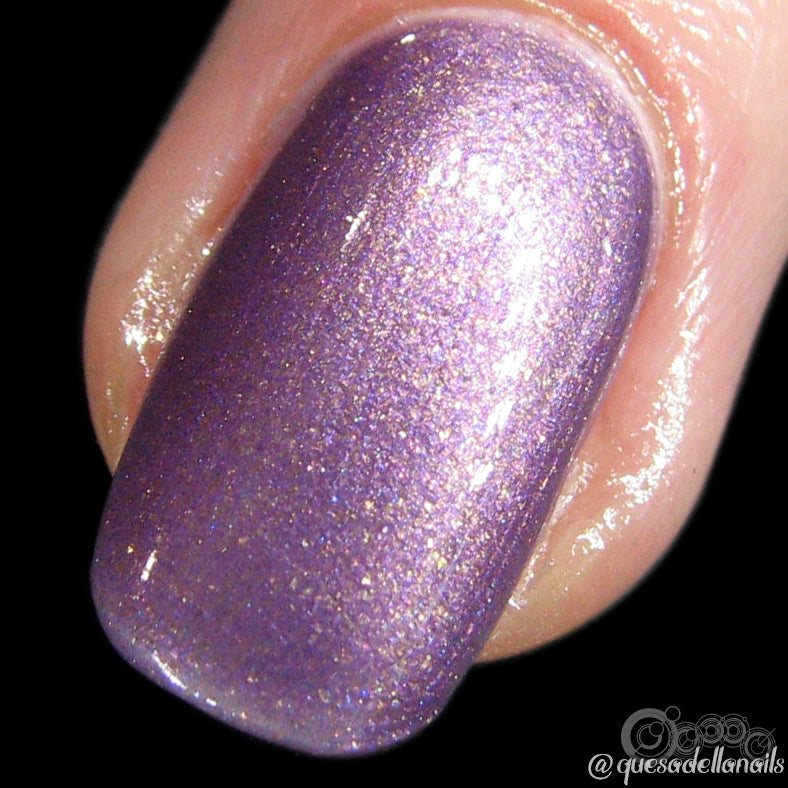 A close-up of a fingernail adorned with PI Colors' Star Road.001 nail lacquer, showcasing a luxurious shimmering chrome purple with tiny sparkles and a glossy finish. The handmade polish is expertly applied to cover the entire nail, set against a black background.