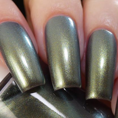 A close-up of three elongated fingernails painted with PI Colors' Light/Forest.000 Green Nail Polish, reflecting light. The neatly manicured nails grip a matching bottle, exuding elegance and style.