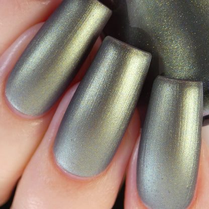 Close-up of fingers with long nails painted in PI Colors' luxurious Light/Forest.000 Green Nail Polish. The smooth and glossy finish accentuates the reflective qualities of this multi-chrome hue.