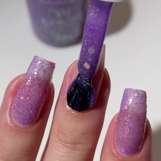 Purple nail polish with iridescent rainbow flakies and holo glitter by PI Colors