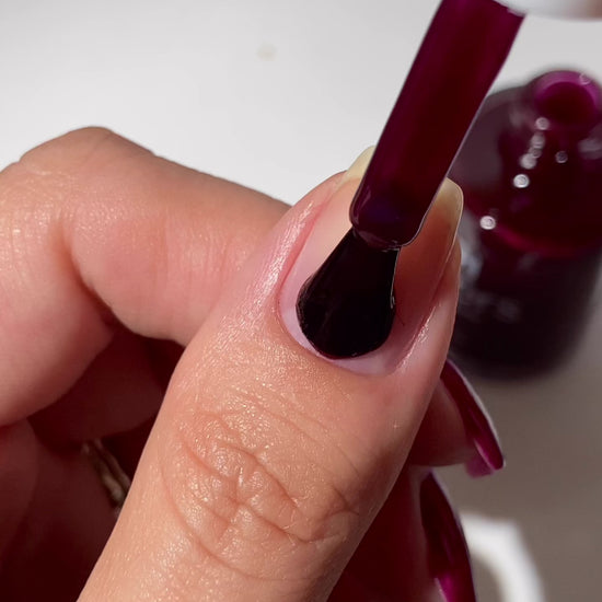 Video of red burgundy nail polish being applied to natural nail