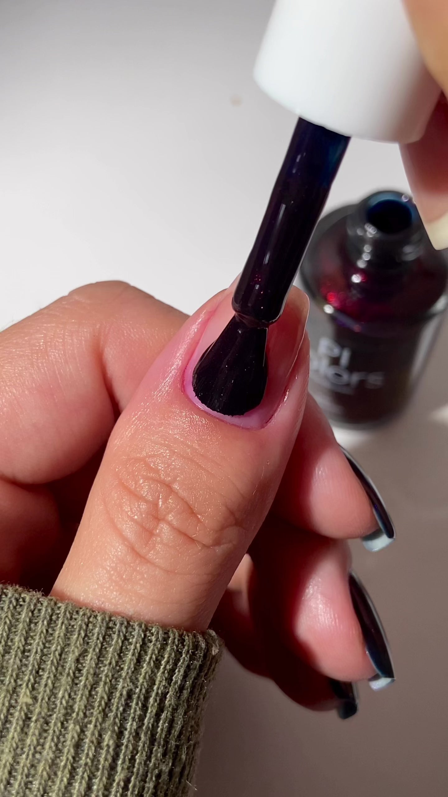 video of dark purple nail polish applied to natural nails