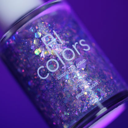 A close-up of a bottle of PI Colors Stained Glass.436 handmade nail polish, featuring a sparkling purple base with holographic glitter, set against a vibrant purple background.