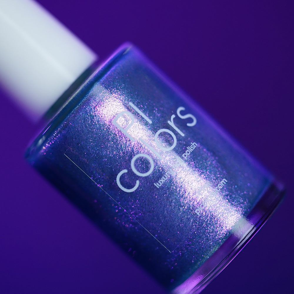 A close-up of PI Colors’ Sugar Sparkles.451 luxury nail lacquer in a shimmery purple shade, set against a matching purple background, highlighting the elegance of handmade polish.